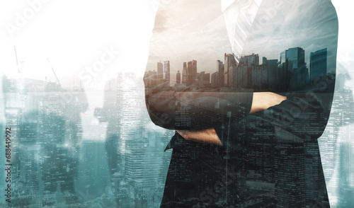 Double Exposure Image of Business Person on modern city background. Future business and communication technology concept. Surreal futuristic cityscape and abstract multiple exposure interface. uds photo