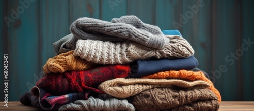 Donating warm knitted clothes, second-hand sweaters for comfort at a thrift shop, in the hygge style. photo