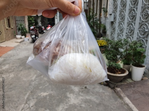 Image of take out food in plastic bags. To go food bag.