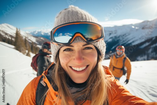 Winter sport smiling young woman selfie portrait against snowy mountains landscape photo
