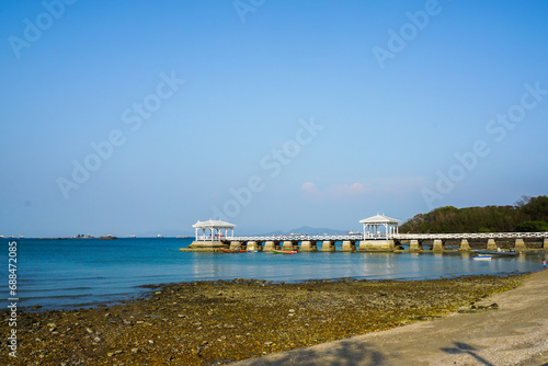 The classic wooden bridge go to white pavilion on the sea. Famous tourist attractions. it's Wooden bridge named 