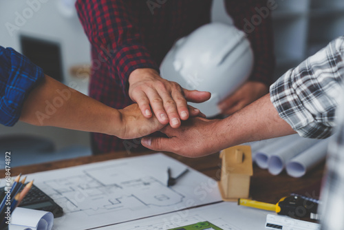 stack hands of business engineering and architect teamwork join together, construction engineer working site, construction engineer conceptual,architect drawing on the architectural project photo