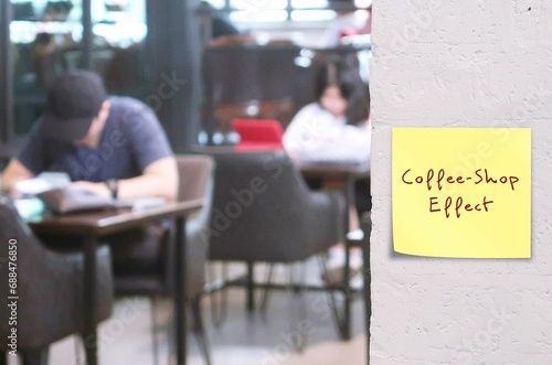 People in cafe with stick note on wall written Coffee-Shop Effect - working in coffee shops seems to make people more creative and productive - filled with productivity-boosting element