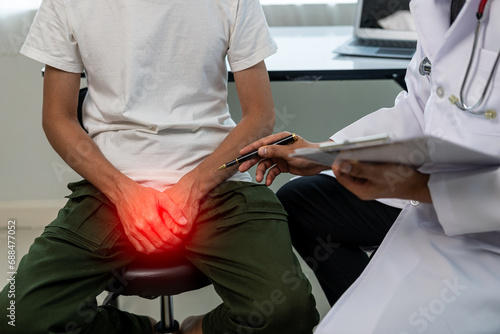 A man consults a doctor about prostate enlargement and frequent urination painThe young man is consulting with a doctor about the cause of erectile dysfunction in the examination room.