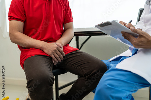 A man consults a doctor about prostate enlargement and frequent urination painThe young man is consulting with a doctor about the cause of erectile dysfunction in the examination room.