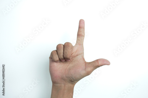 Close-ups of girl left hand are pointing to the up side, it is a sign language meaning reverse L or letter of LOVE symbol sign and hand upside down isolated on a white background.