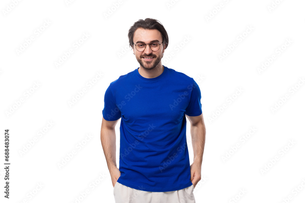 portrait of a young brunette man with a well-groomed beard dressed in a blue t-shirt on a white background with copy space portrait of a young brunette man with a well-groomed beard dressed in a blue t-shirt on a white background with copy space