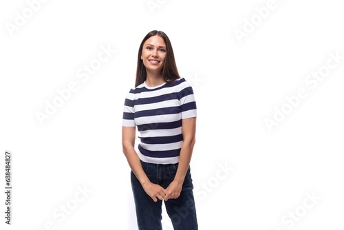 young slender European woman with black straight hair is dressed in a striped black and white t-shirt