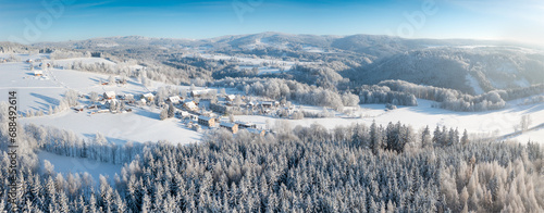 Aerial view to winter landscape. Snow-covered trees at sunny day. Lomy, Osečnice, Orlicke hory, Eagle Mountains photo