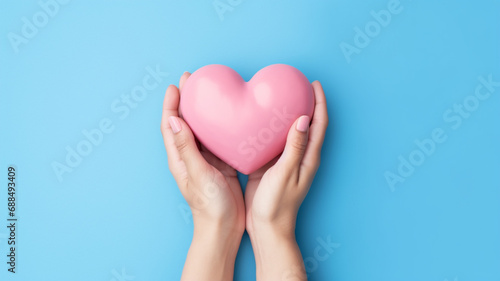 Heart in hands on a minimal background. Charity  health  care  love concept.