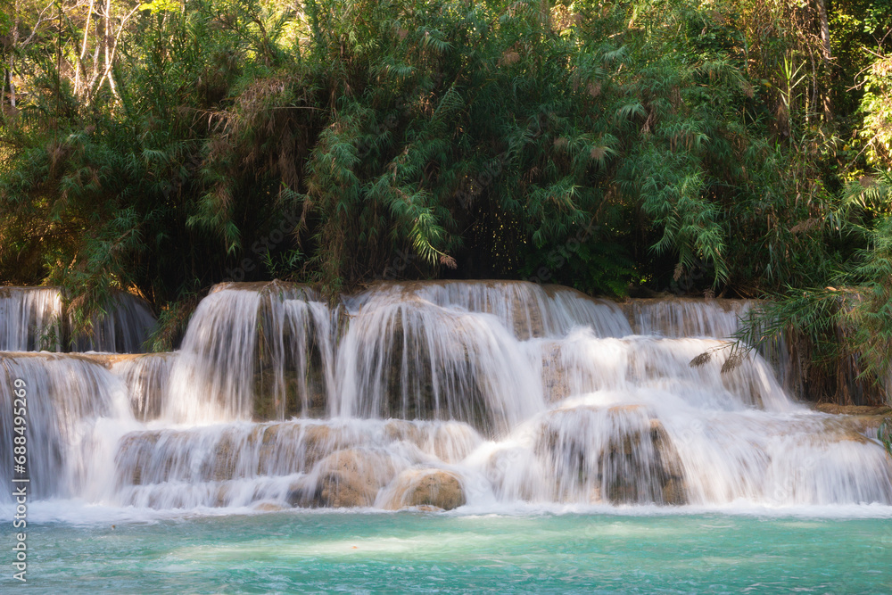 Kuang Si Waterfall is a limestone waterfall. The water in the waterfall is therefore emerald green. Luang Prabang, Laos Kuang Si Waterfall is a limestone waterfall. The water in the waterfall is therefore emerald green. Luang Prabang, Laos