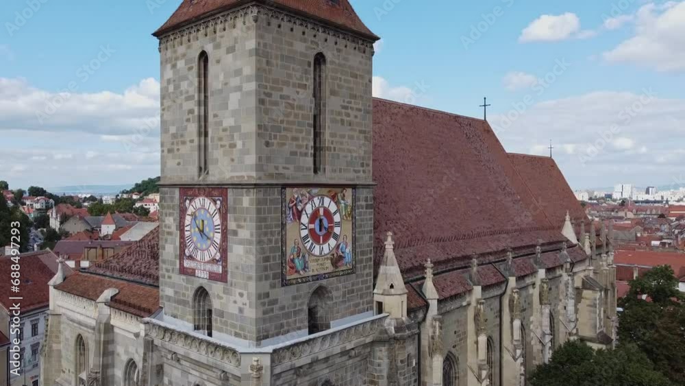 Rising drone shot of tower of black church over cityscape of Brasov in Romania Rising drone shot of tower of black church over cityscape of Brasov in Romania