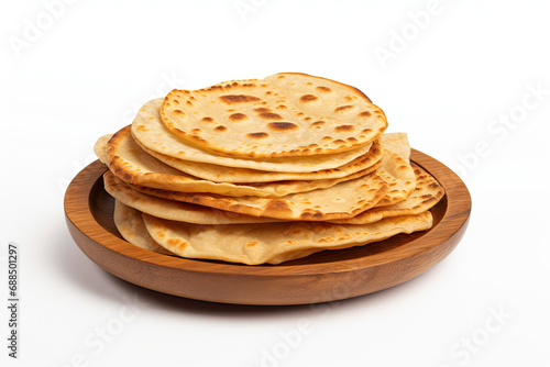 pile of indian canai bread on a wooden plate isolated on a white background