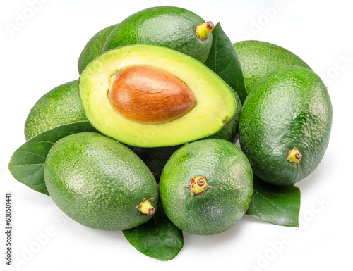 Lot of avocado fruits with leaves isolated on white background.