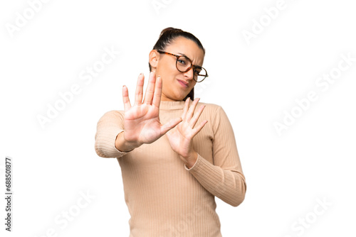 Young beauty woman over isolated chroma key background nervous stretching hands to the front © luismolinero