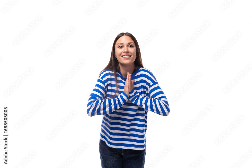 portrait of a young pretty caucasian woman with dark hair dressed in a blue striped sweatshirt on a white background. people lifestyle concept portrait of a young pretty caucasian woman with dark hair dressed in a blue striped sweatshirt on a white background. people lifestyle concept
