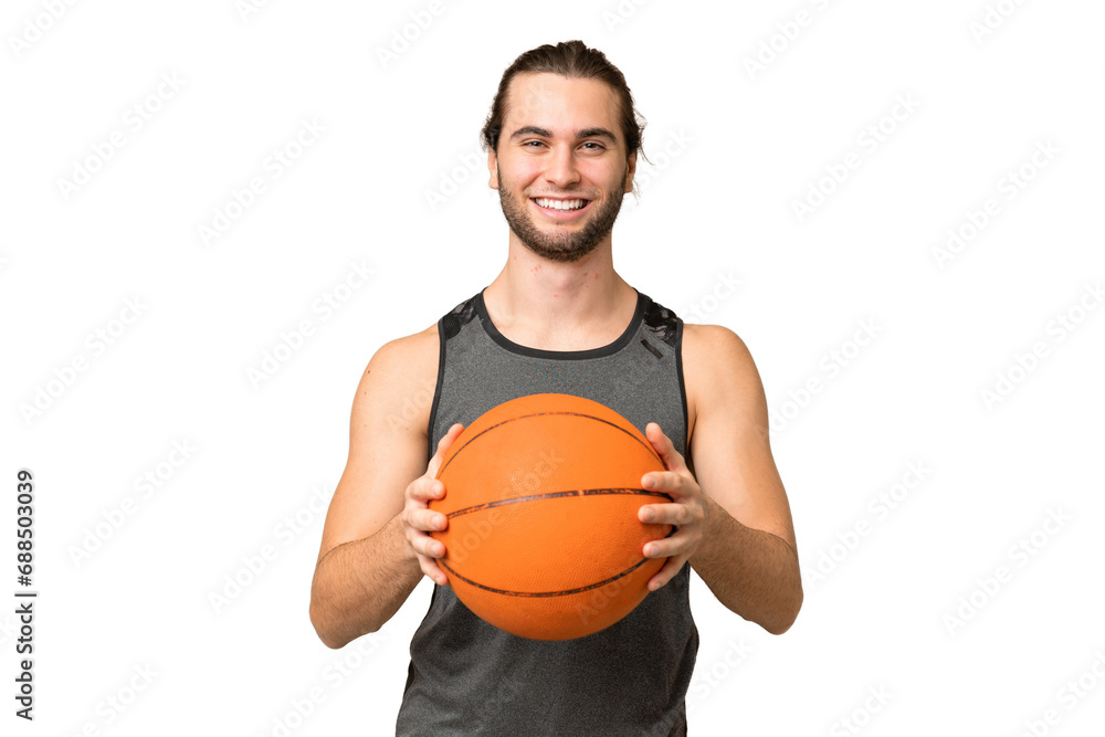 Young handsome man isolated on green chroma background playing basketball