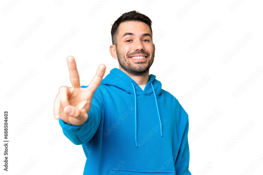 Young handsome caucasian man over isolated chroma key background smiling and showing victory sign Young handsome caucasian man over isolated chroma key background smiling and showing victory sign