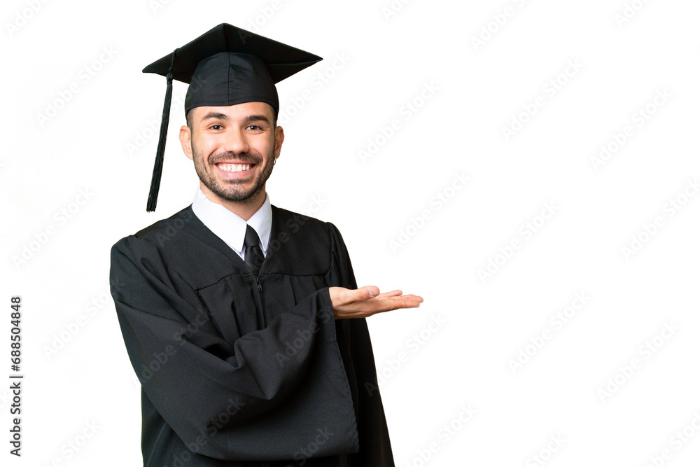 Young university graduate man over isolated chroma key background presenting an idea while looking smiling towards Young university graduate man over isolated chroma key background presenting an idea while looking smiling towards