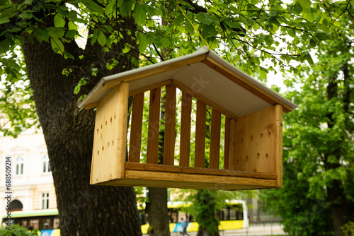 Beautiful wooden bird feeder in the park © Atlas