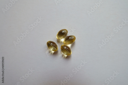 Top view of four softgel capsules of vitamin D © Anna