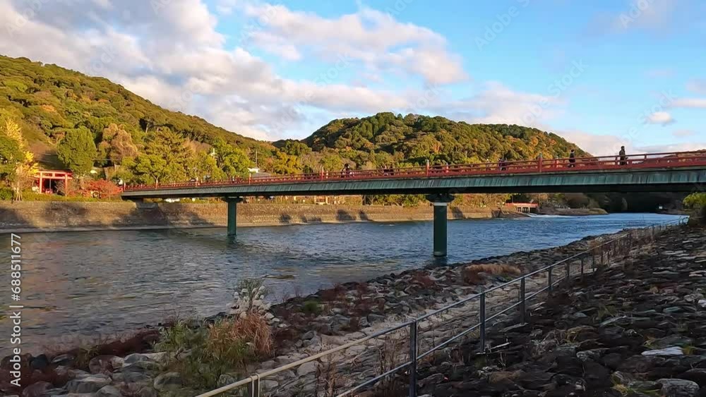 red Asagiribashi Bridge to Furitsu Uji Park at Uji, Kyoto. Beautiful autumn sunset in Japan. River landscape in Uji red Asagiribashi Bridge to Furitsu Uji Park at Uji, Kyoto. Beautiful autumn sunset in Japan. River landscape in Uji