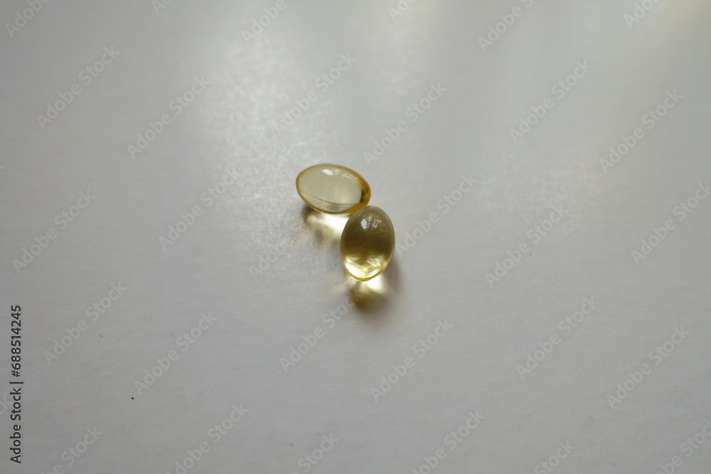 Close view of two softgel capsules of vitamin D Close view of two softgel capsules of vitamin D