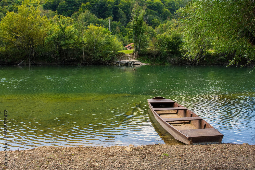 A wooden boat on the River Una north of Martin Brod, Bihac, in the Una National Park. Una-Sana Canton, Federation of Bosnia and Herzegovina. Early September