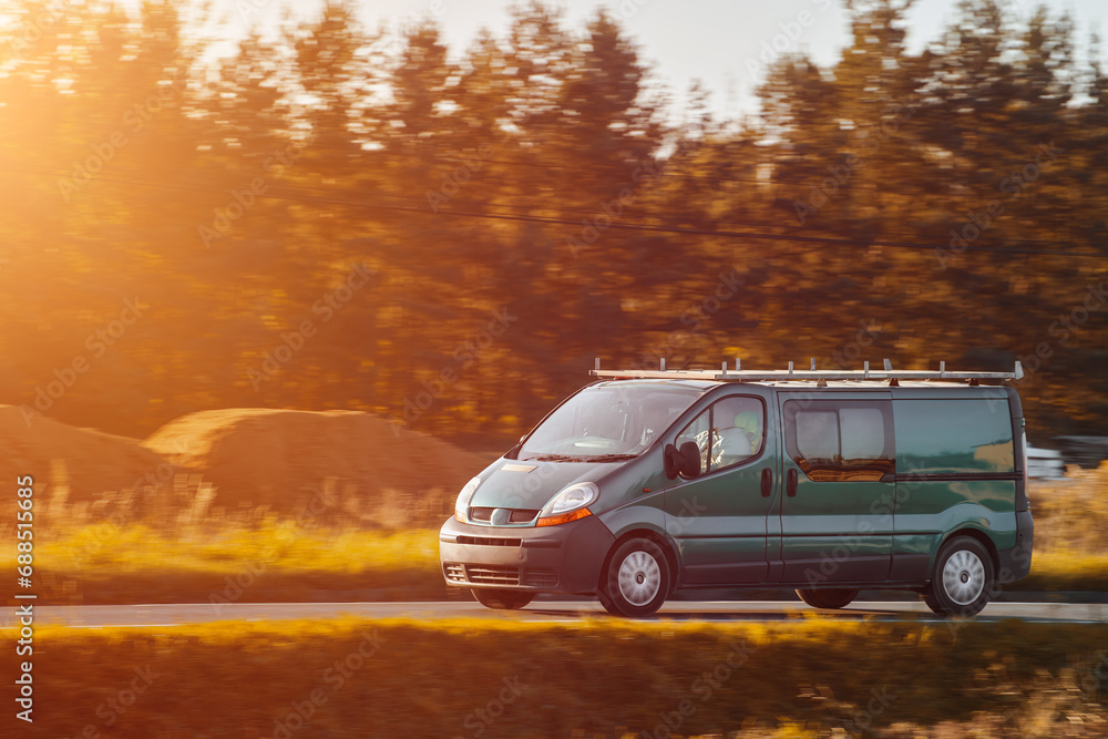 A commercial van truck on the highway, delivering goods and products across the country, using fast and reliable modes of freight transportation.