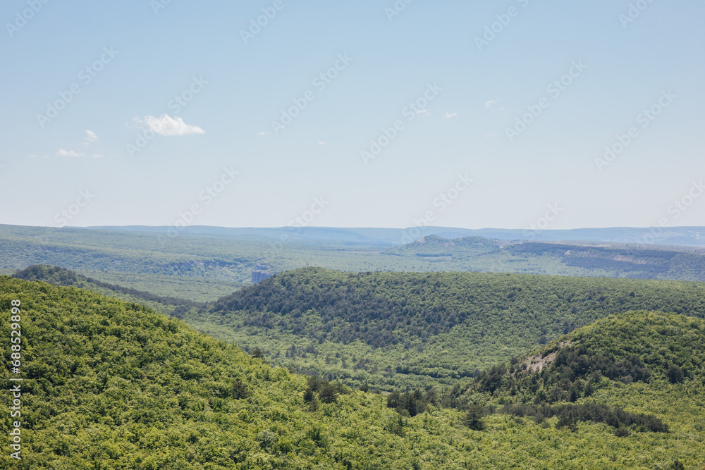 Beautiful landscape of mountains, rocks, green forest and blue sky
