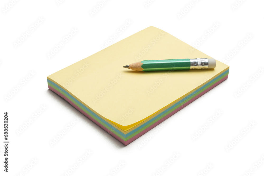 Block of colored sticky notes with a green pencil Block of colored sticky notes with a green pencil