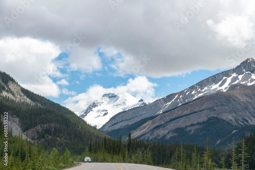 Drivers view over the road of Icefields Parkway in Jasper National Park, AB, Canada with in background Mount Athabasca and its horned-shaped tip called Silverhorn located in the Columbia Icefield