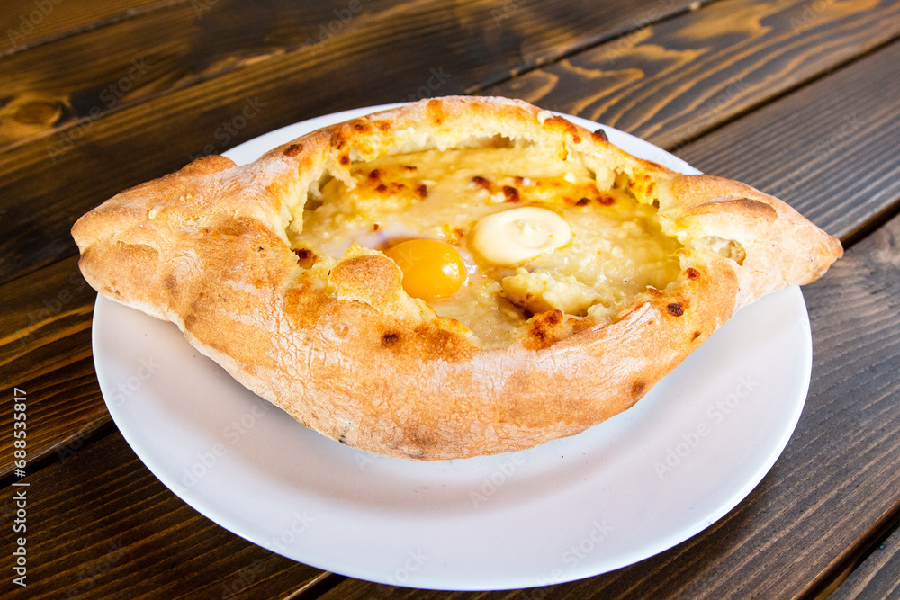 travel to Georgia - khachapuri in Adjarian style (boat shaped with soft cheese, egg, butter) in local cafe in Batumi city