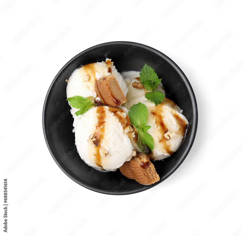 Tasty ice cream with caramel sauce, mint, candies and nuts in bowl isolated on white, top view Tasty ice cream with caramel sauce, mint, candies and nuts in bowl isolated on white, top view