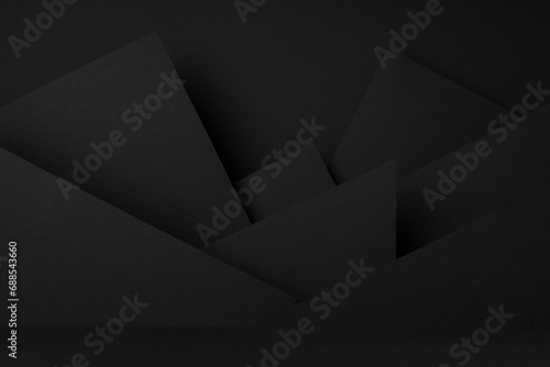 Exquisite black stage mockup with abstract geometric pattern of corners, angles, flat shapes, triangles as relief for presentation cosmetic products, goods, advertising, design in graphic style.