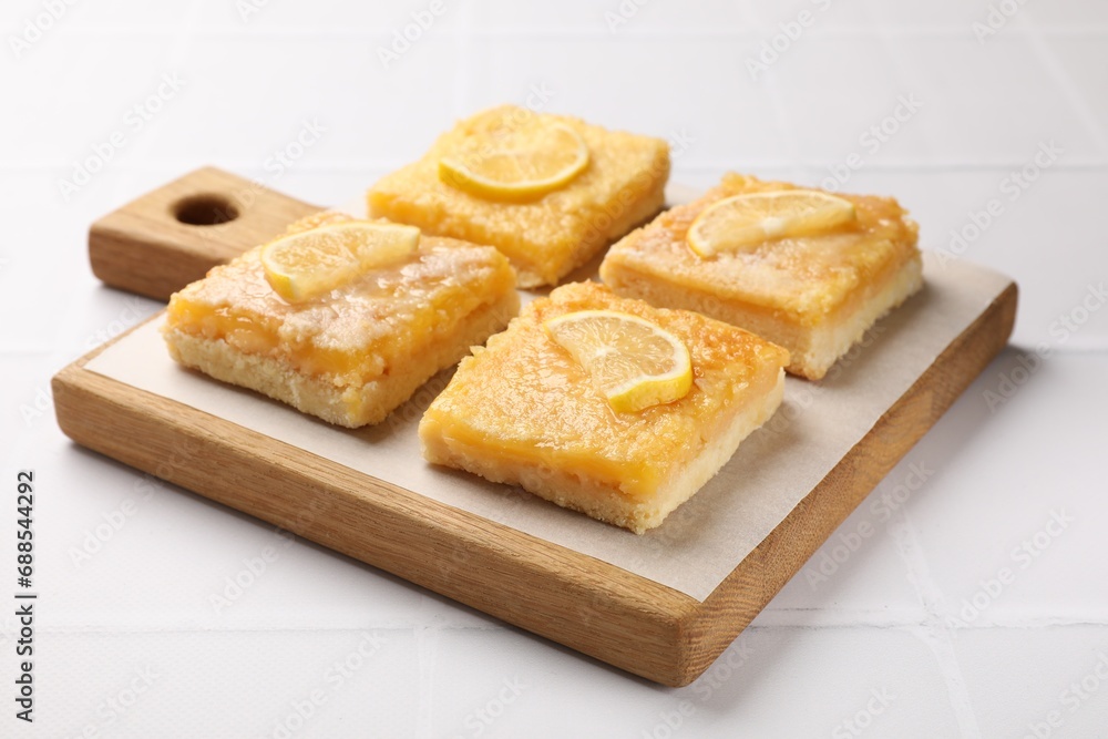 Tasty lemon bars on white tiled table, closeup Tasty lemon bars on white tiled table, closeup