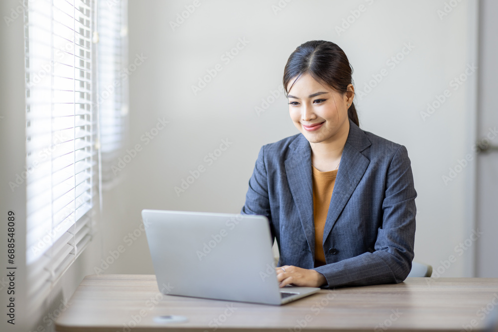 Asian Business woman work on laptop for doing math finance on an office desk, tax, report, accounting, statistics, and analytical research concept
Asian Business woman work on laptop for doing math finance on an office desk, tax, report, accounting, statistics, and analytical research concept