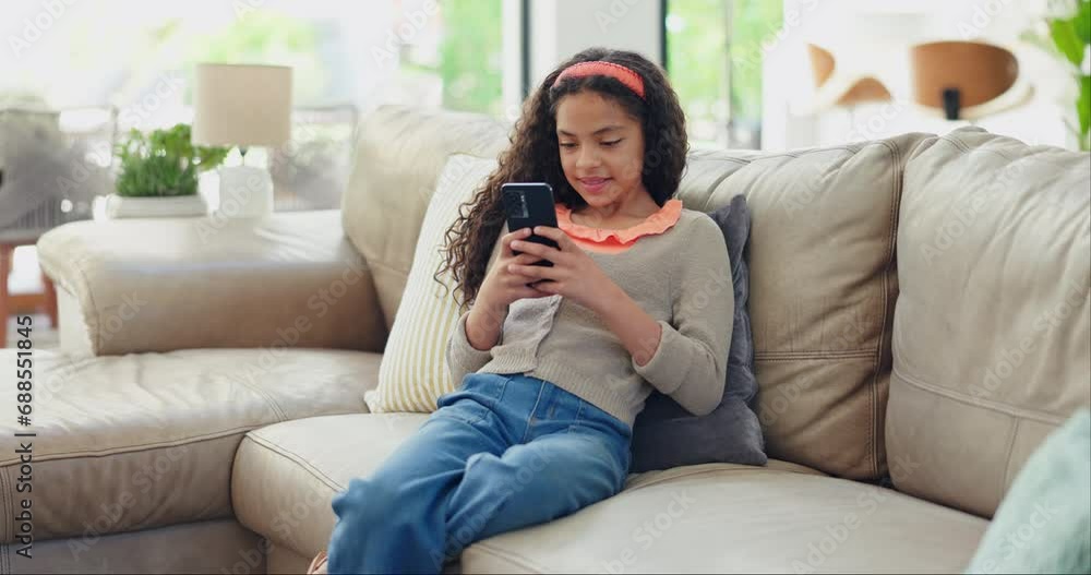 Phone, search and girl child on a sofa with social media, chat or streaming games in her home. Smartphone, app and female kid in a living room online for children entertainment, cartoon or playing Phone, search and girl child on a sofa with social media, chat or streaming games in her home. Smartphone, app and female kid in a living room online for children entertainment, cartoon or playing