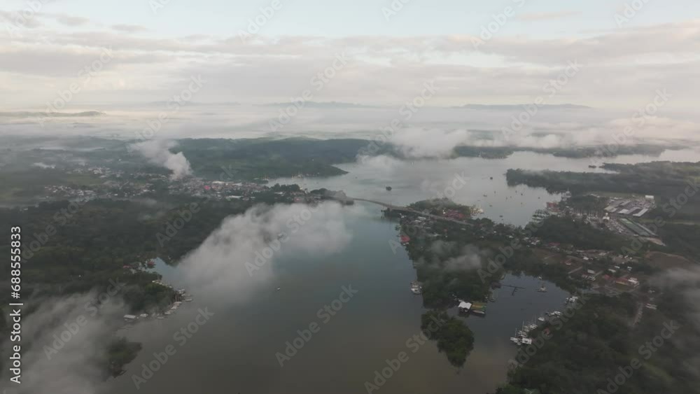 Wide view of Rio dulce with big bridge during foggy morning, aerial Wide view of Rio dulce with big bridge during foggy morning, aerial