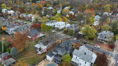 Small town America during autumn. Aerial view of houses and homes lining quaint street. photo