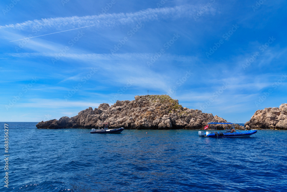 Dubrovnik, Croatia - August 03,2023: uninhabited island in Croatia and boats around the island