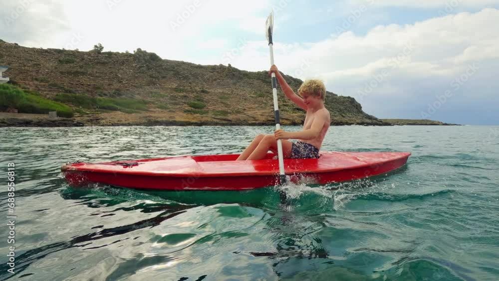 Boy's Serene Kayaking Through Crete's Tranquil Waters Boy's Serene Kayaking Through Crete's Tranquil Waters
