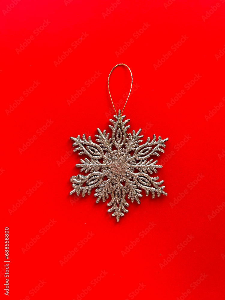 Beautiful Christmas decorations, golden glittering snowflake on a bright red background. Christmas poster design. Poster for the new year Beautiful Christmas decorations, golden glittering snowflake on a bright red background. Christmas poster design. Poster for the new year