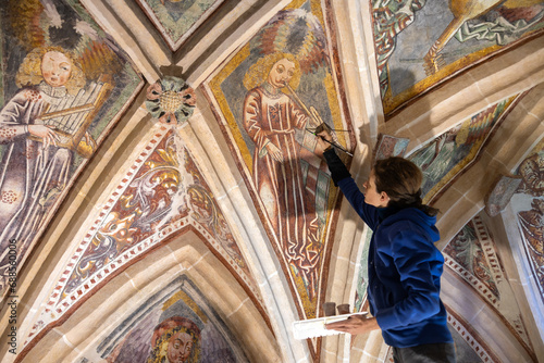 Adult Woman Expertise Restorer Retouching Antique Gothic Fresco Under Church Ceiling - Parish Church, Slovenia, Europe