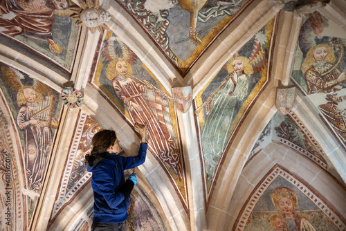 Female Expertise Restorer Retouching Antique Gothic Fresco Under Church Ceiling - Parish Church, Slovenia, Europe
