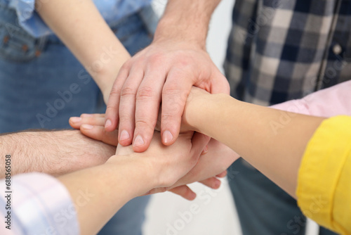 People holding hands together in office  closeup