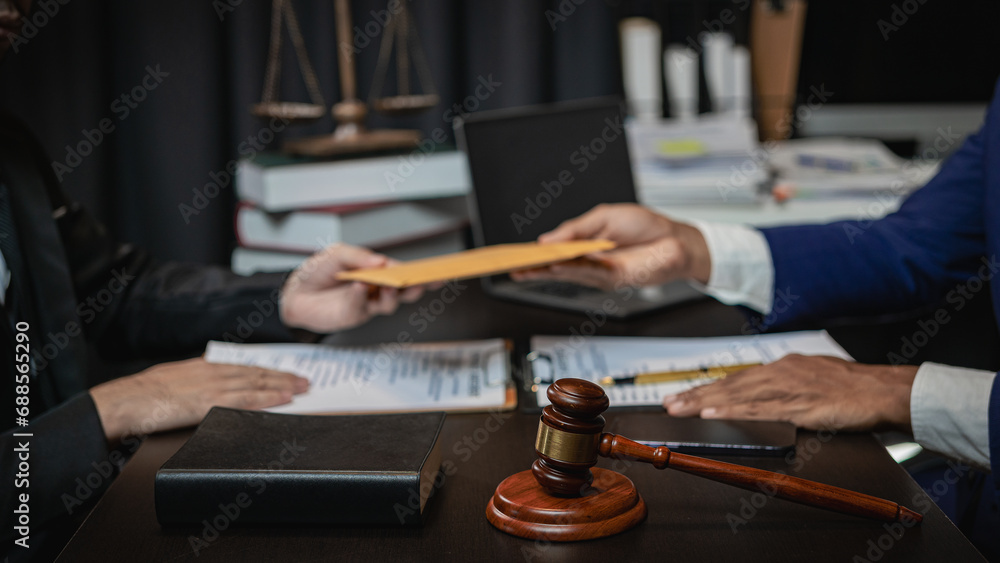 Businessman and male lawyer discuss team meeting
Judge hammer and justice scales having team meeting at law office