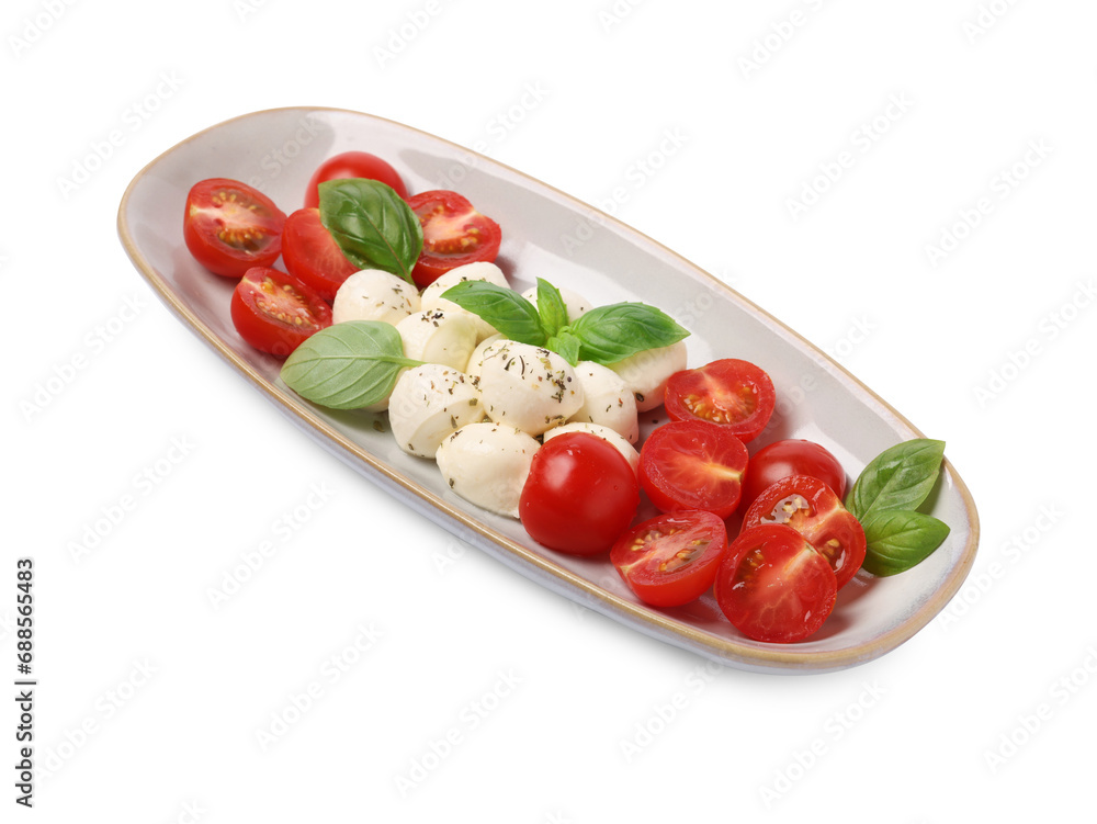 Plate of delicious Caprese salad with tomatoes, mozzarella, basil and spices isolated on white Plate of delicious Caprese salad with tomatoes, mozzarella, basil and spices isolated on white