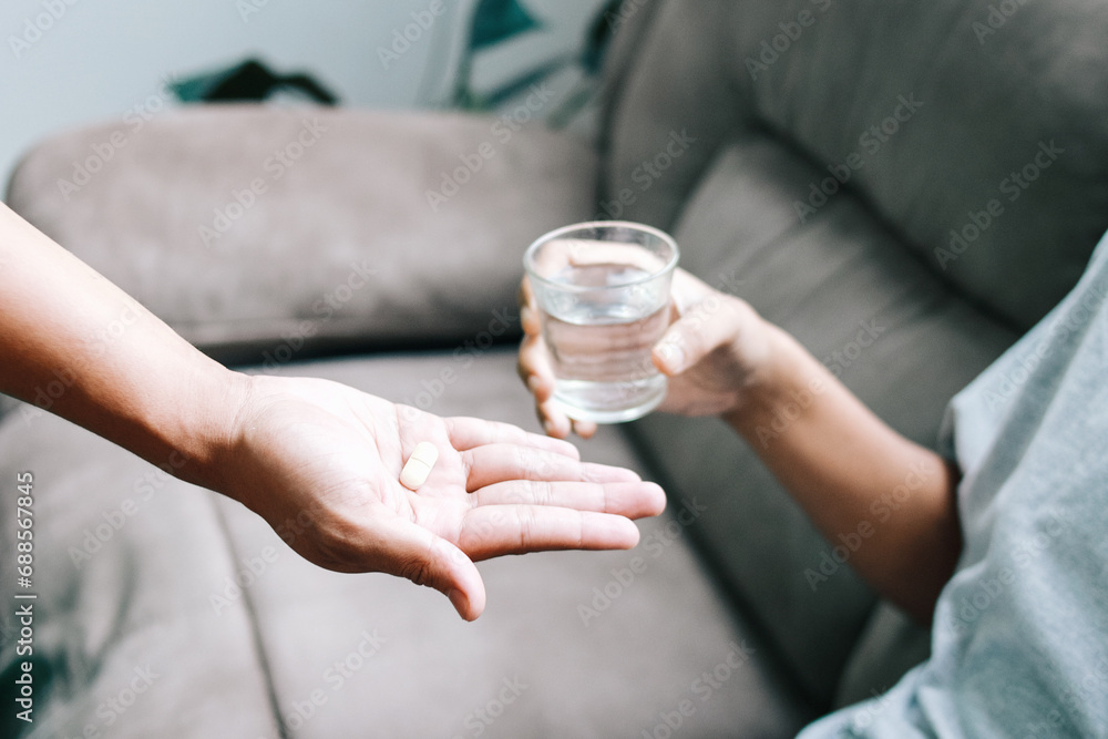 Doctor hands giving medicine pill to the patient in the clinic Doctor hands giving medicine pill to the patient in the clinic