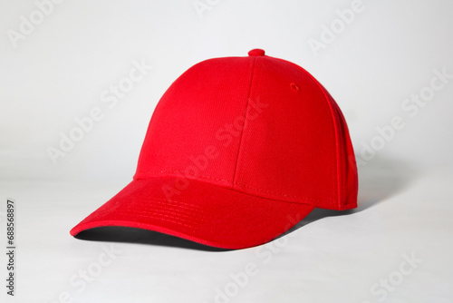 Stylish red baseball cap on white background